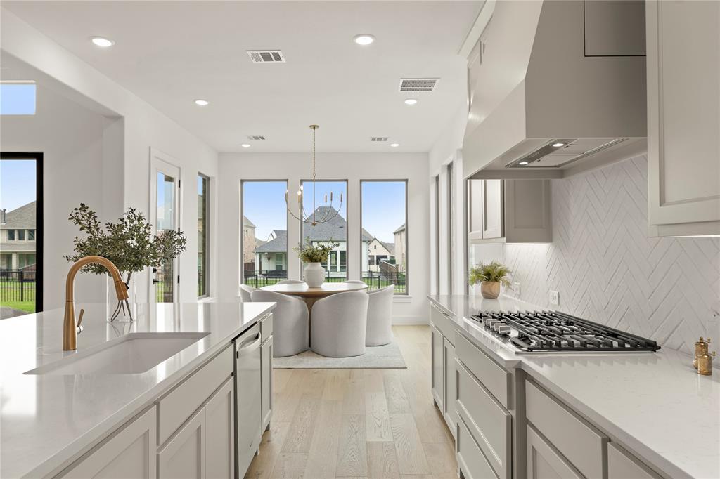 Bright White Kitchen with Herringbone Backsplash