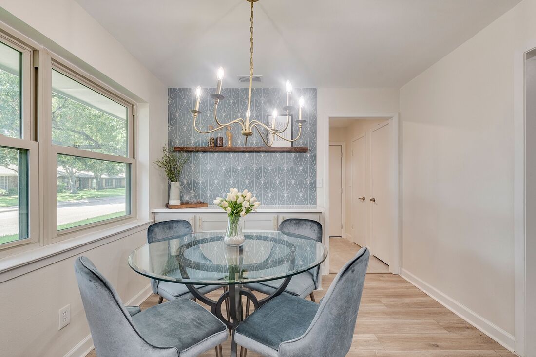 Cute Breakfast nook with blue tile accent wall and staged dining set by Prime Home Staging